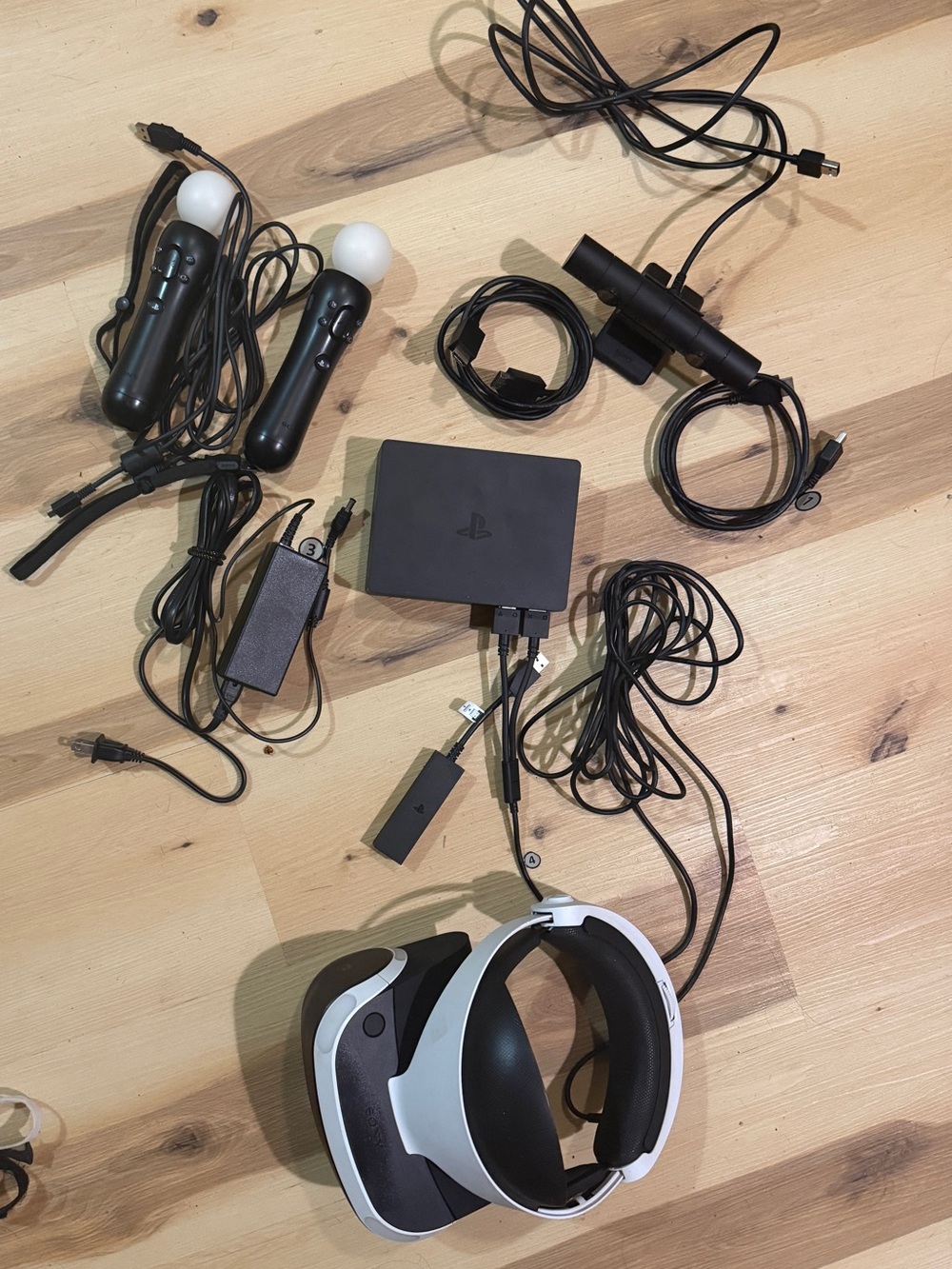 Sony PSVR headset with Black motion controllers and White headset accents